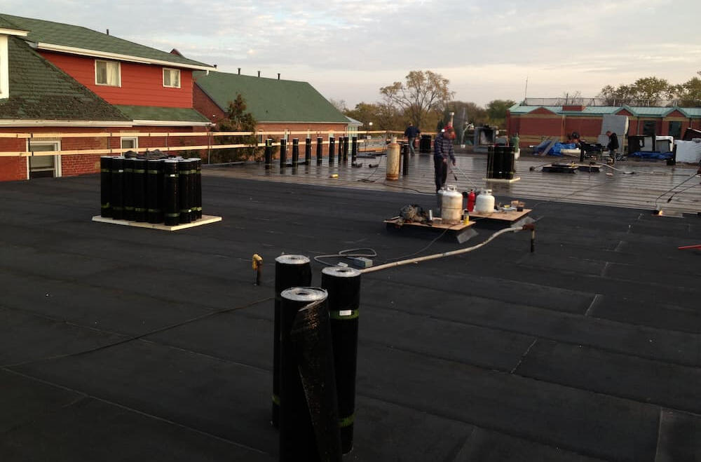 Conventional tar and gravel flat roof surfarce